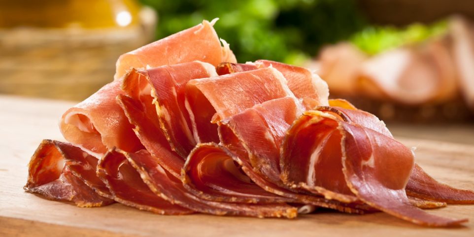 Sliced Italian Prosciutto on Wood Cutting Board